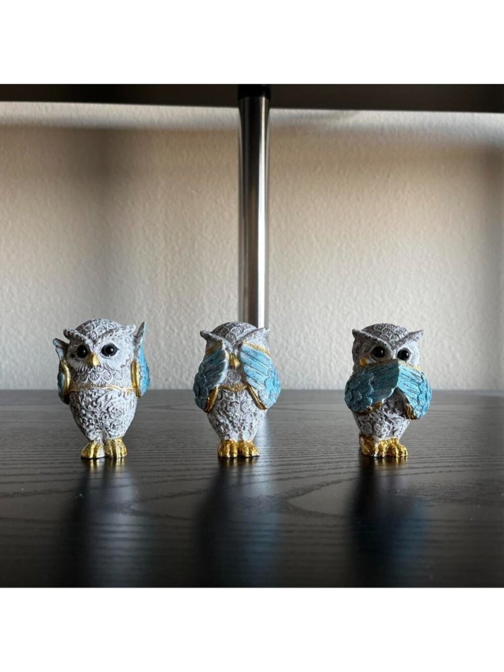 Three owl figurines with white base and blue/gold accents #owl #figurines